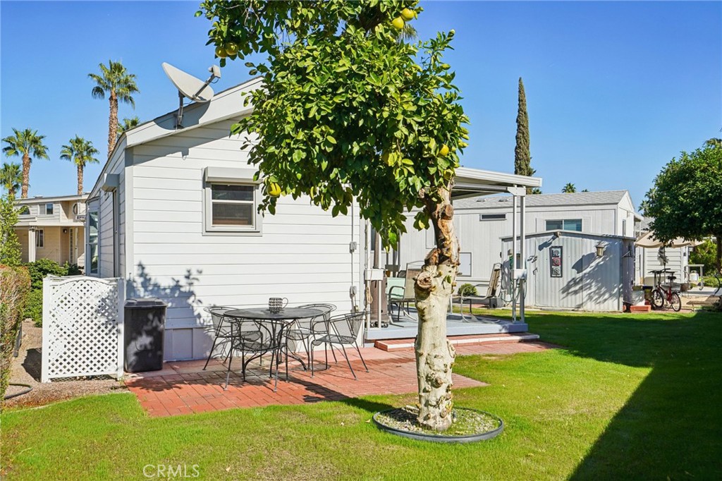 81620 Ave 49, Unit 174 Indio, CA 92201 - Photo 26 of 37 a view of a patio with a table and chairs