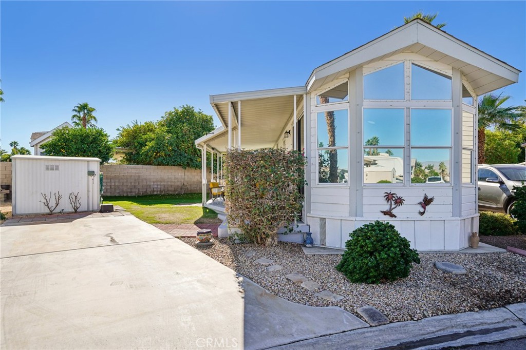 81620 Ave 49, Unit 174 Indio, CA 92201 - Photo 3 of 37 a front view of a house with garden