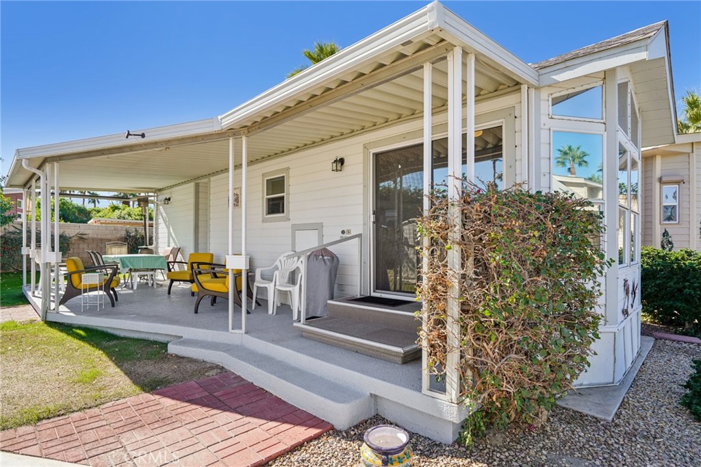 81620 Ave 49, Unit 174 Indio, CA 92201 - Photo 4 of 37 a front view of a house with outdoor seating