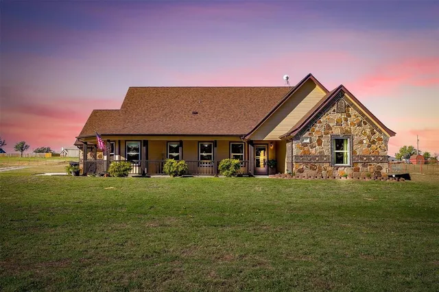 a front view of house with yard outdoor seating and green space