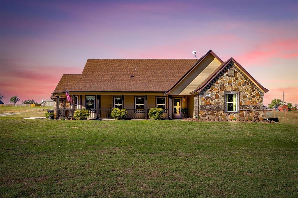 a front view of house with yard outdoor seating and green space