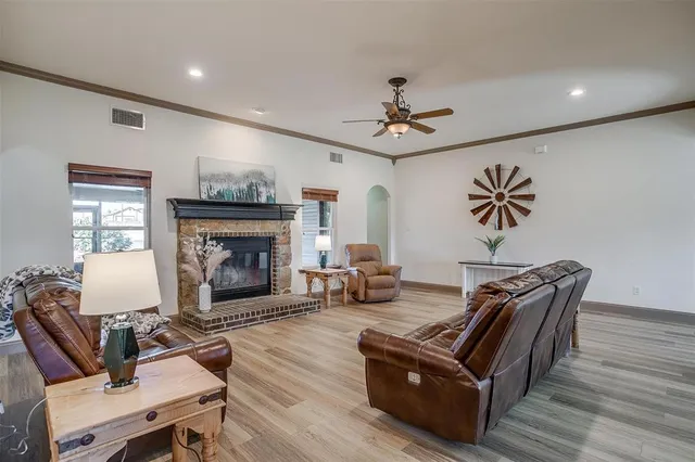 a living room with furniture fireplace and wooden floor