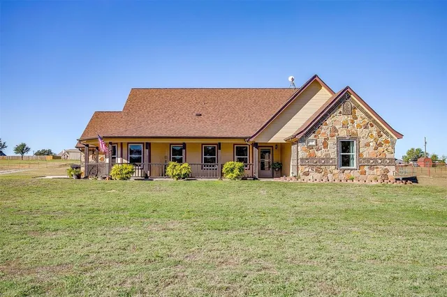 a front view of a house with a garden and porch