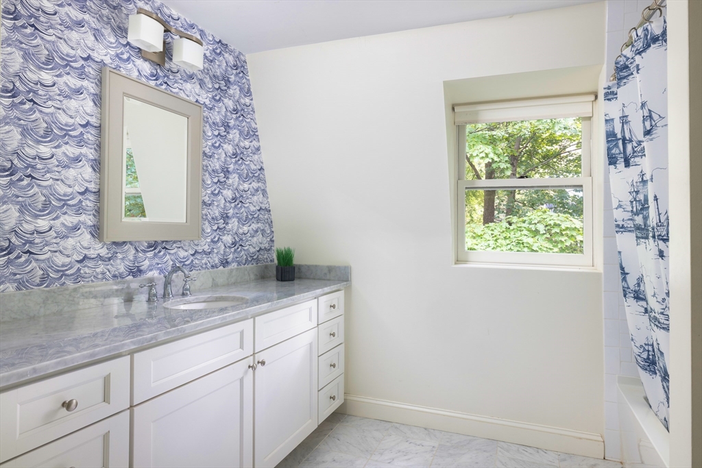 9 Ripley Street, Unit 1 Newton, MA 02459 - Photo 13 of 20 a bathroom with a granite countertop sink a vanity and a mirror