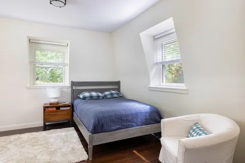 a bedroom with a bed and window