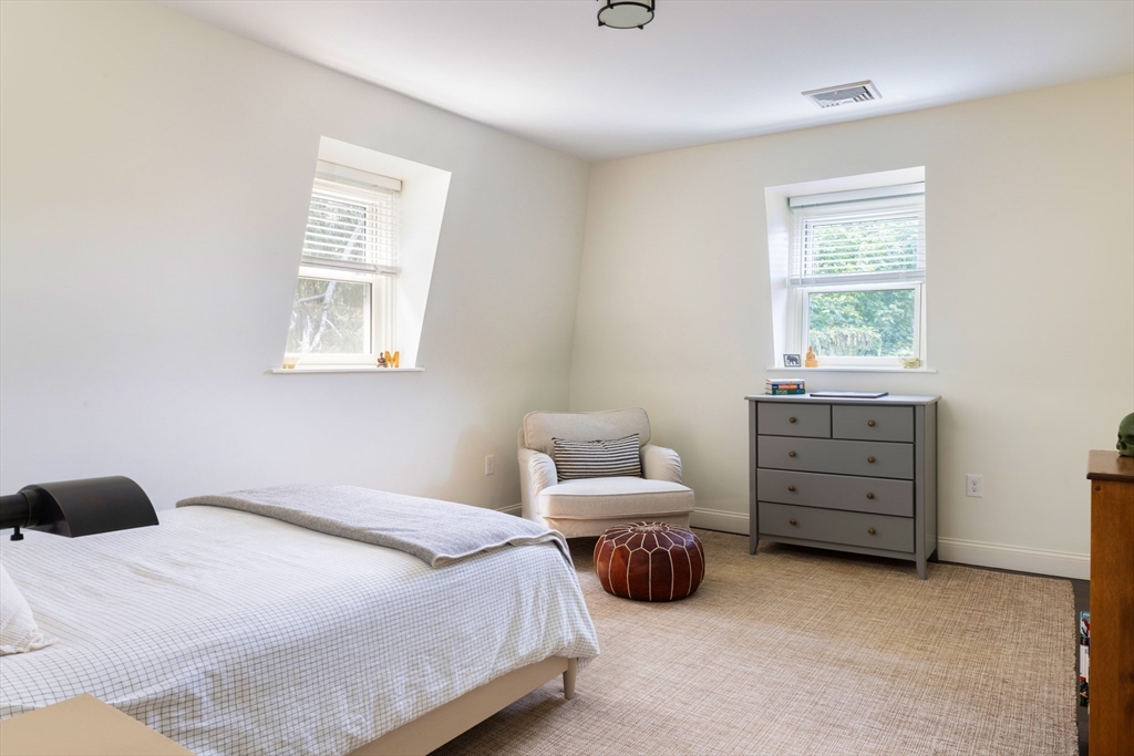 9 Ripley Street, Unit 1 Newton, MA 02459 - Photo 17 of 20 a bedroom with bed and a window