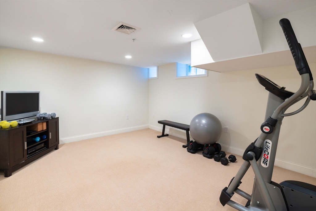 9 Ripley Street, Unit 1 Newton, MA 02459 - Photo 18 of 20 a room with furniture and a flat screen tv