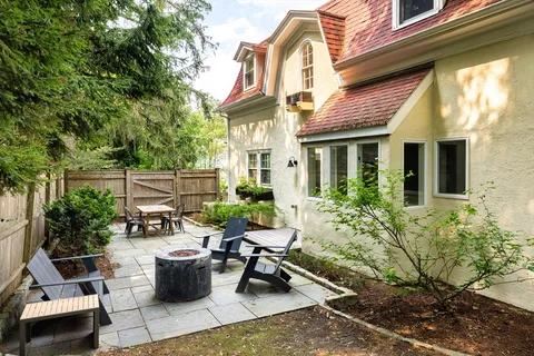 a view of a patio with chairs and potted plants