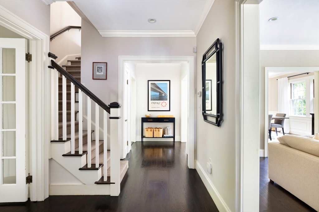 9 Ripley Street, Unit 1 Newton, MA 02459 - Photo 2 of 20 a view of a hallway with wooden floor and stairs