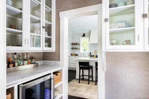 a view of a center island with a table and chairs in a kitchen