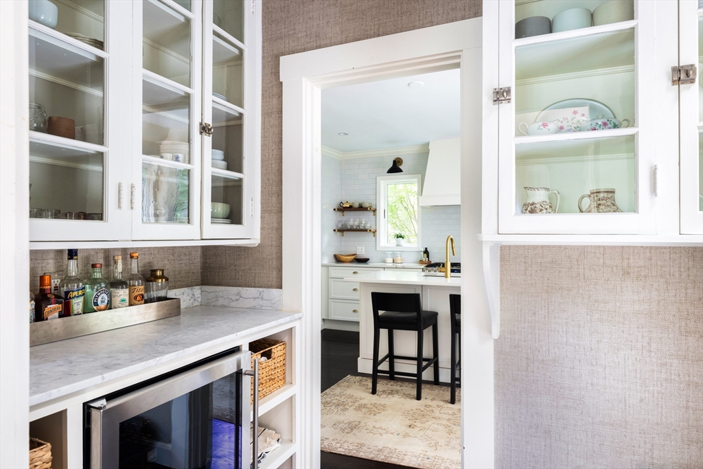 9 Ripley Street, Unit 1 Newton, MA 02459 - Photo 6 of 20 a view of a center island with a table and chairs in a kitchen