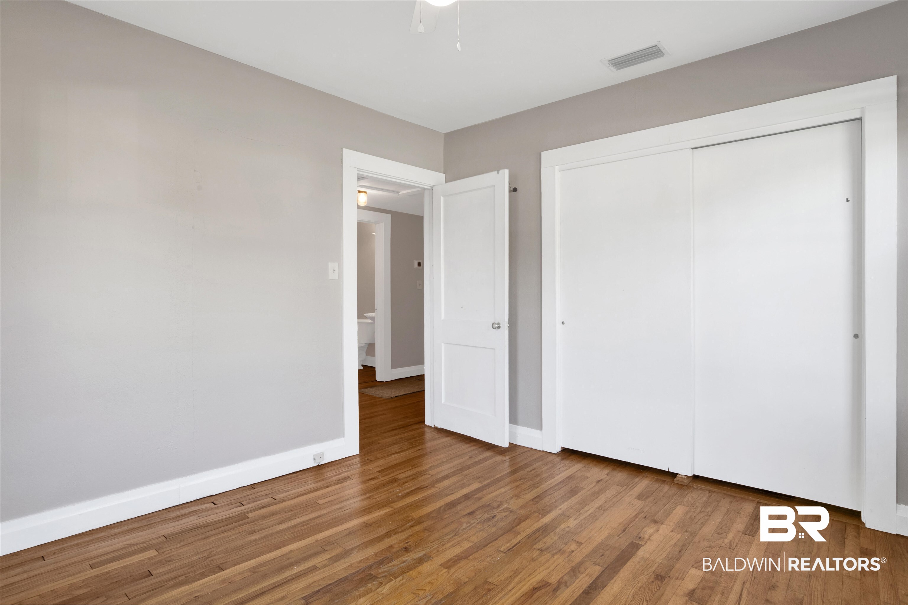 160 Emogene Place Mobile, AL 36606 - Photo 23 of 32 Unfurnished bedroom with wood finished floors and a closet