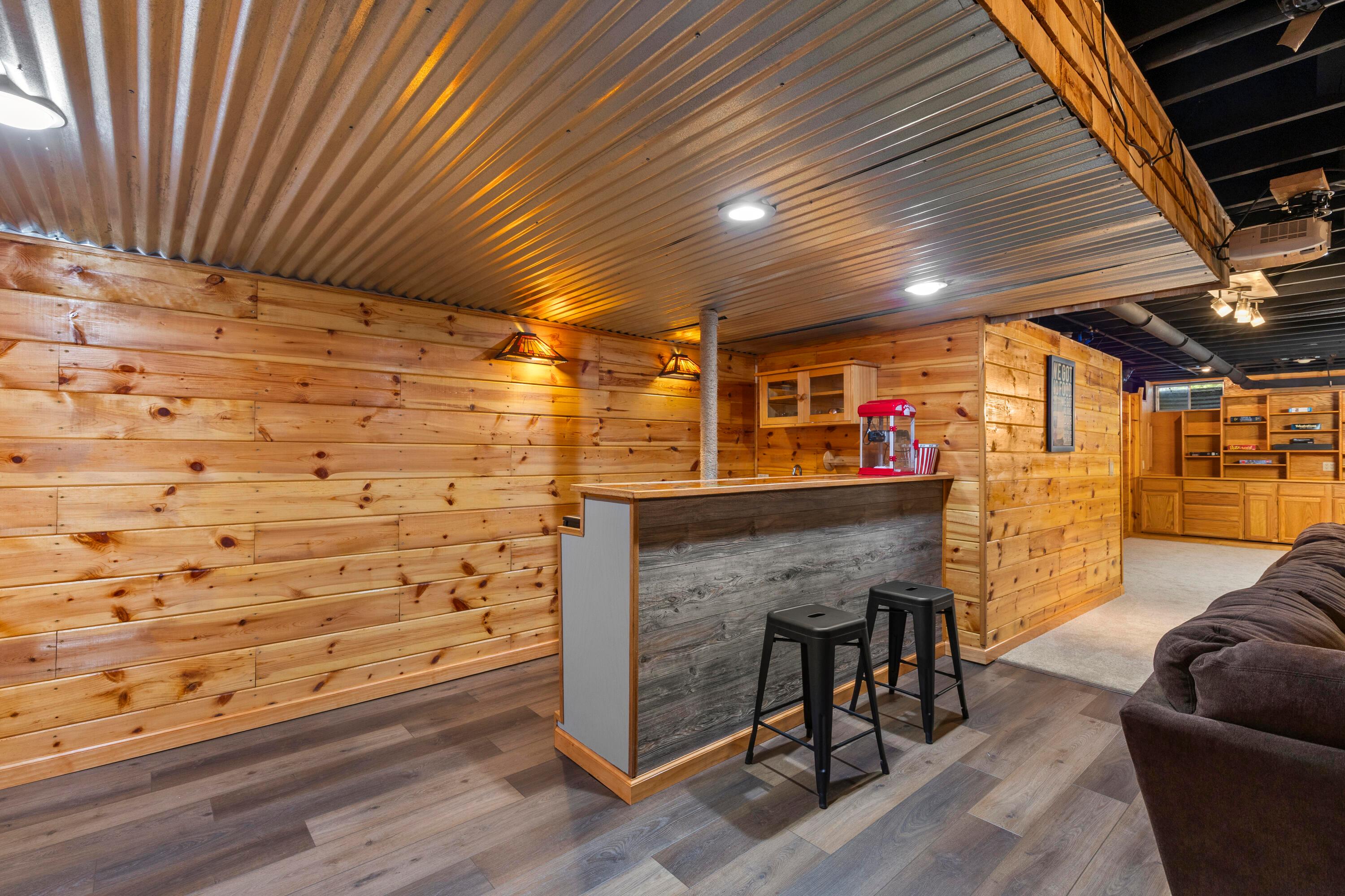 1515 Dale Ford Road Delaware, OH 43015 - Photo 56 of 74 • New luxury vinyl plank flooring ~ 2025 • Wood paneled walls • Wall mounted light • Bar ledge • Single bowl stainless steel sink (not connected) • Danby® refrigerator remians