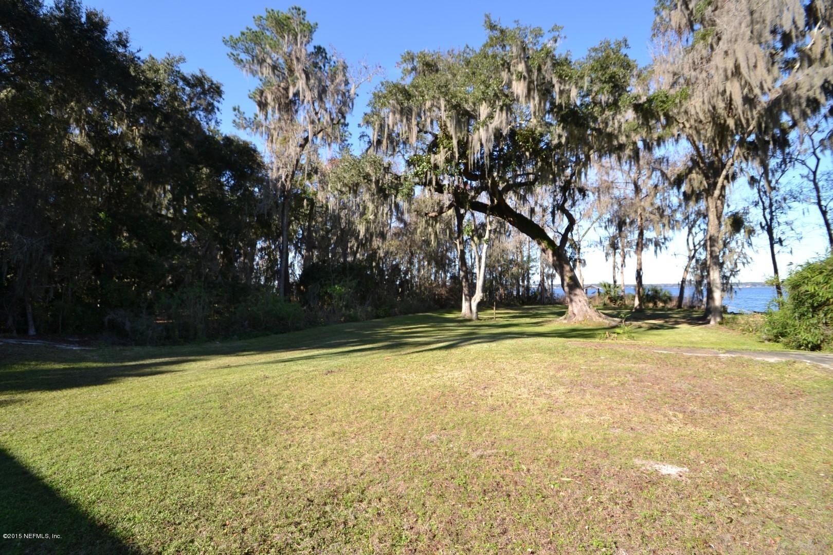 76 Harmony Hall Road Middleburg, FL 32068 - Photo 15 of 67 a view of a swimming pool with trees in the background