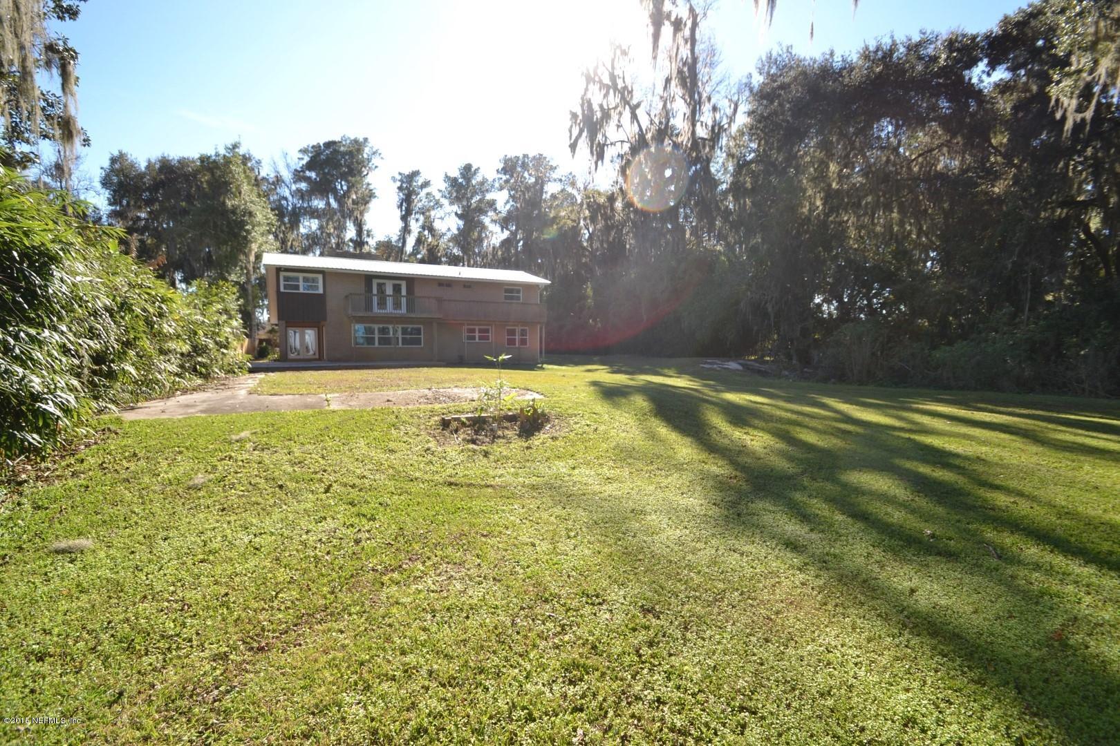 76 Harmony Hall Road Middleburg, FL 32068 - Photo 17 of 67 a swimming pool with trees in the background