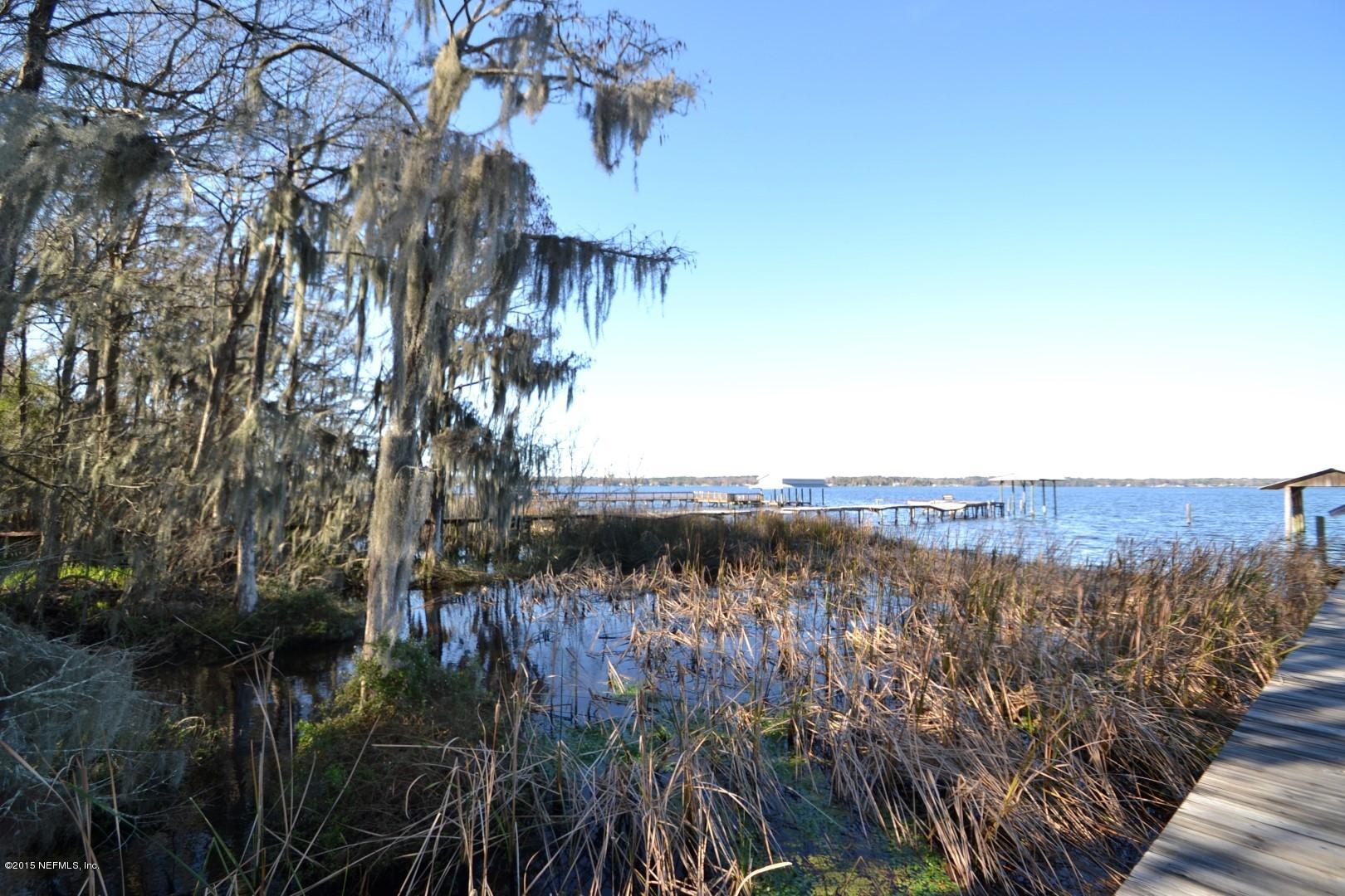 76 Harmony Hall Road Middleburg, FL 32068 - Photo 19 of 67 a view of a lake with a mountain in the background