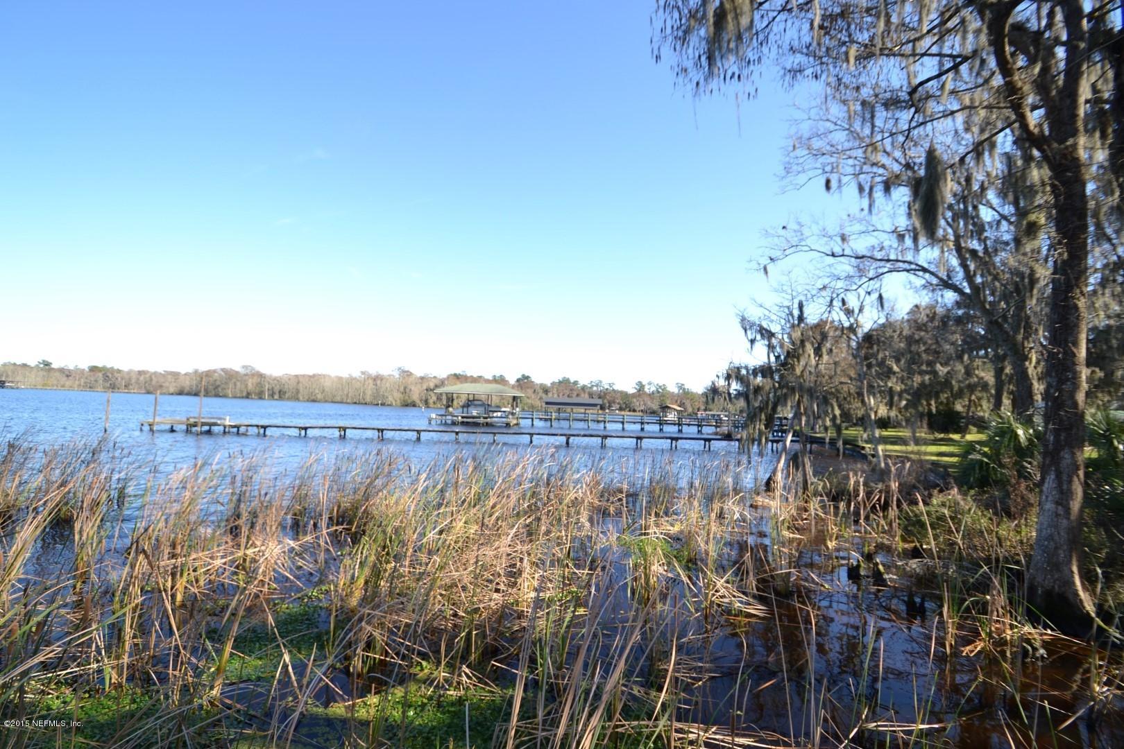 76 Harmony Hall Road Middleburg, FL 32068 - Photo 20 of 67 a view of a lake with a mountain in the background