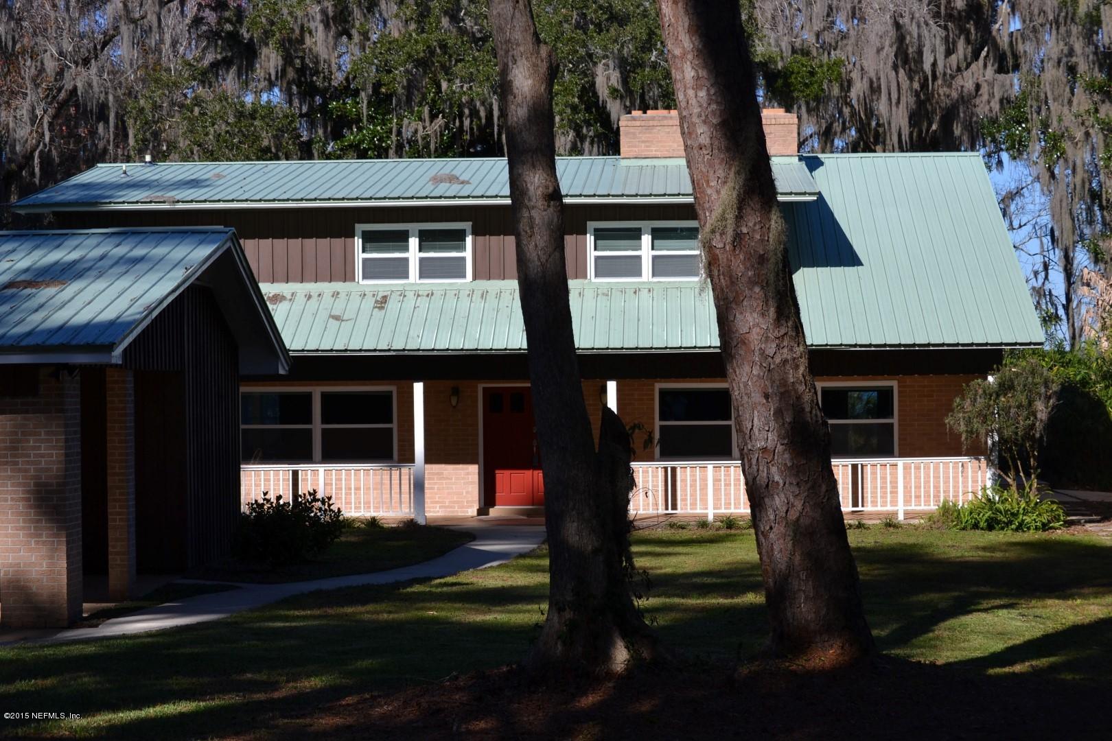 76 Harmony Hall Road Middleburg, FL 32068 - Photo 2 of 67 a front view of a house with a garden
