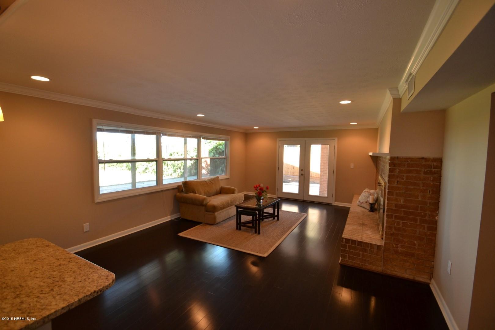 76 Harmony Hall Road Middleburg, FL 32068 - Photo 30 of 67 a living room with furniture and large windows
