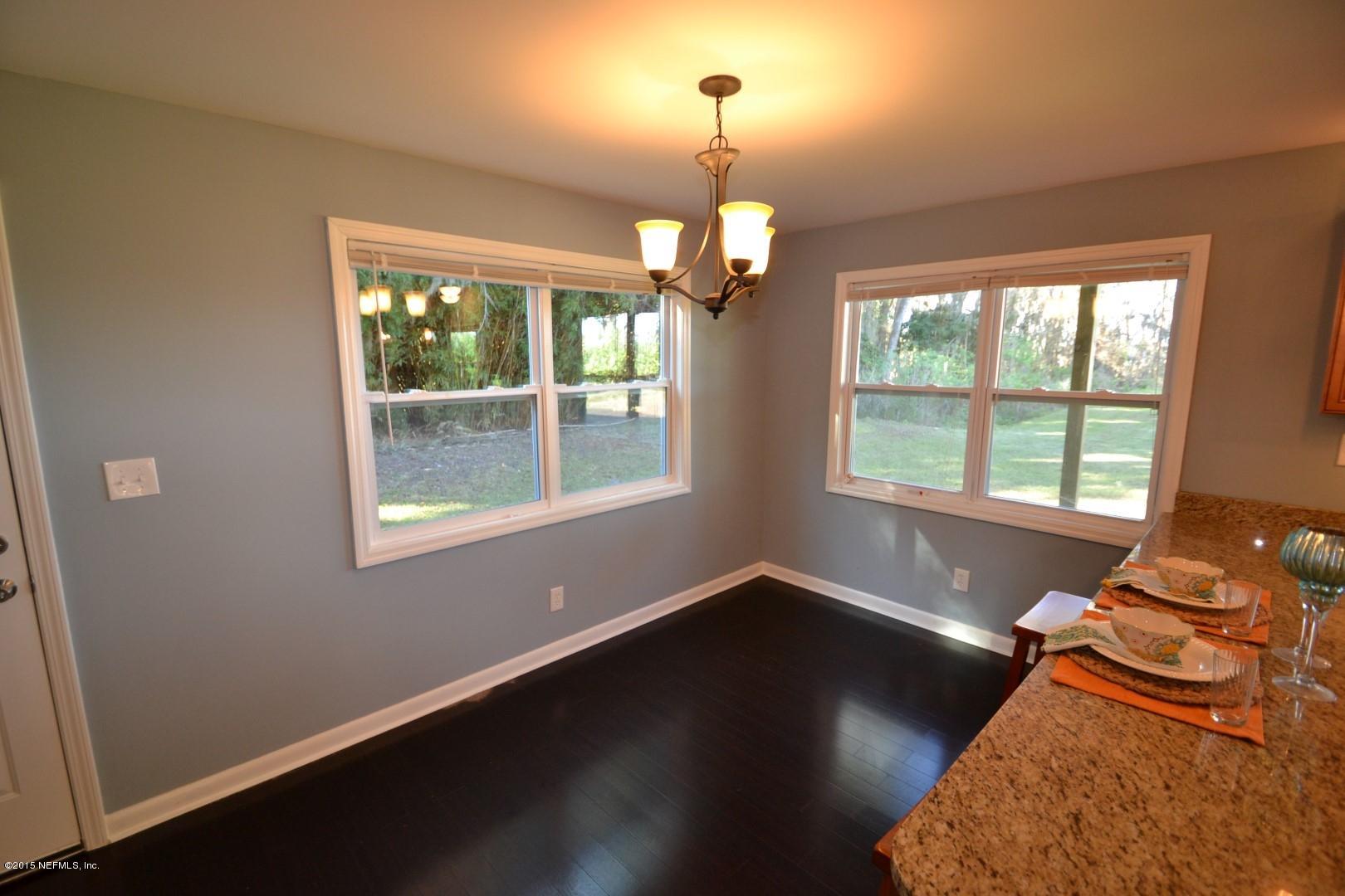 76 Harmony Hall Road Middleburg, FL 32068 - Photo 38 of 67 a room with wooden floor chandelier and a window