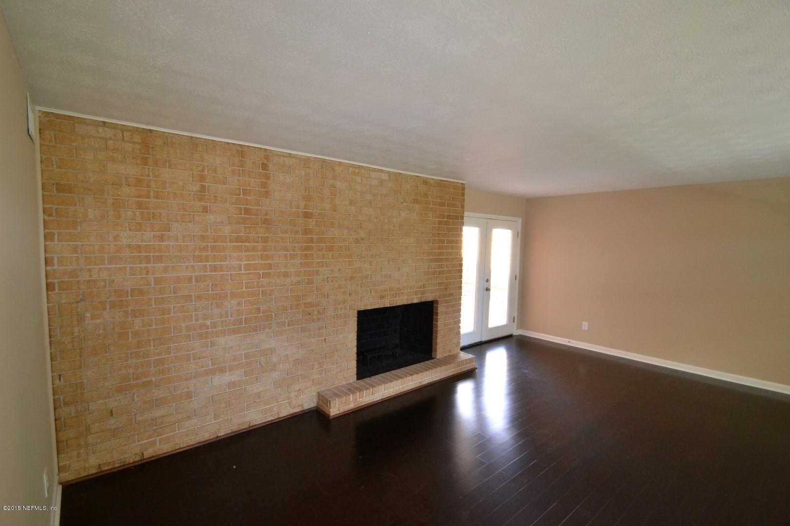 76 Harmony Hall Road Middleburg, FL 32068 - Photo 45 of 67 a view of empty room with wooden floor and fireplace