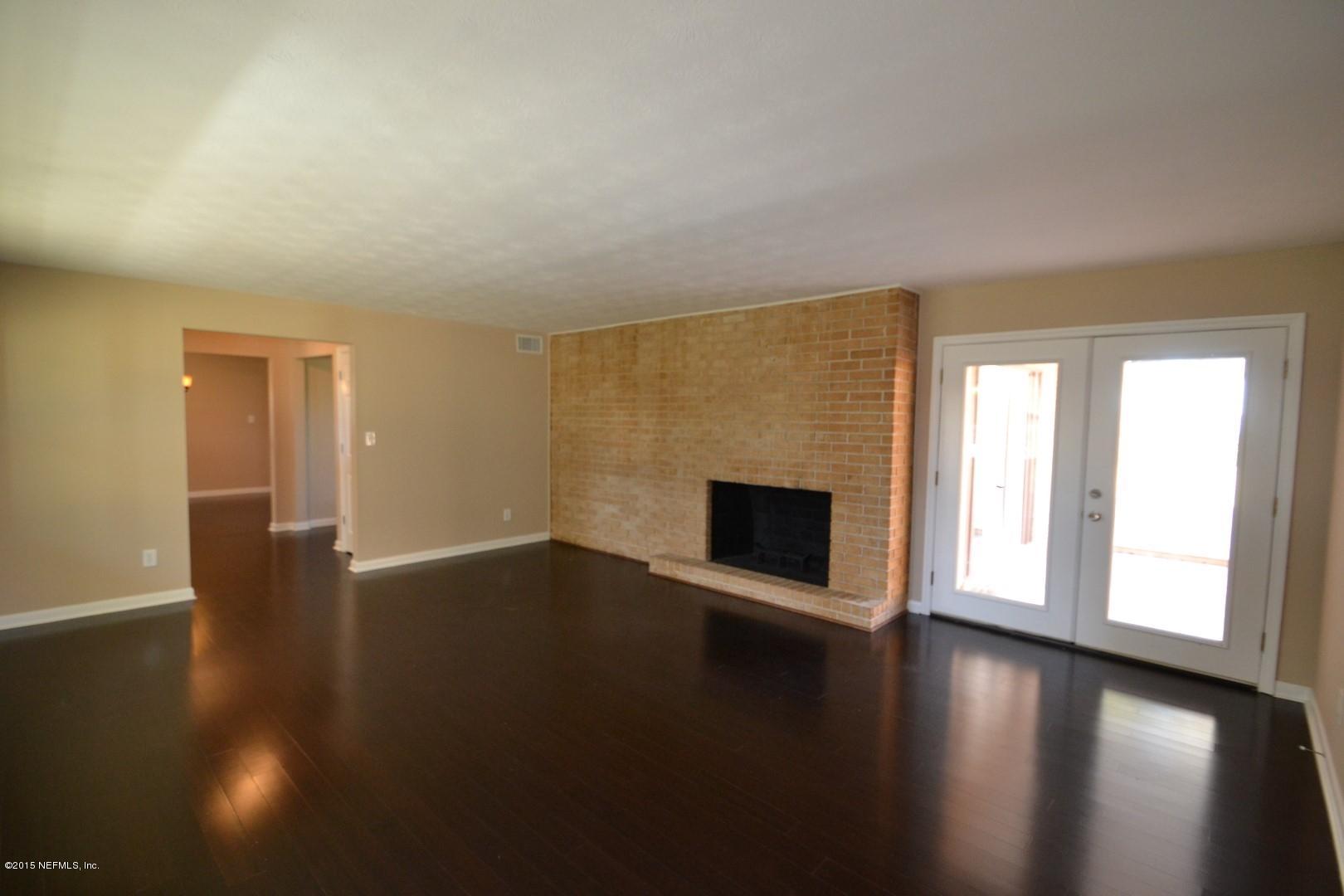 76 Harmony Hall Road Middleburg, FL 32068 - Photo 47 of 67 a view of a livingroom with wooden floor and a fireplace