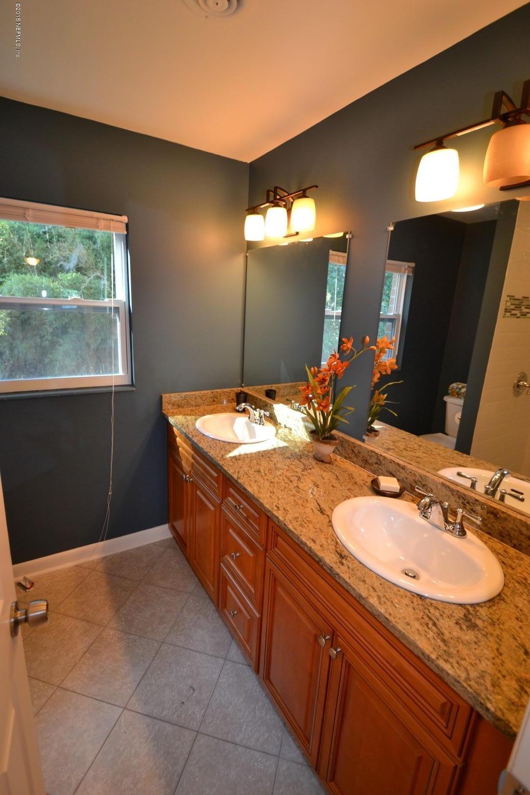 76 Harmony Hall Road Middleburg, FL 32068 - Photo 49 of 67 a bathroom with a granite countertop sink and a mirror