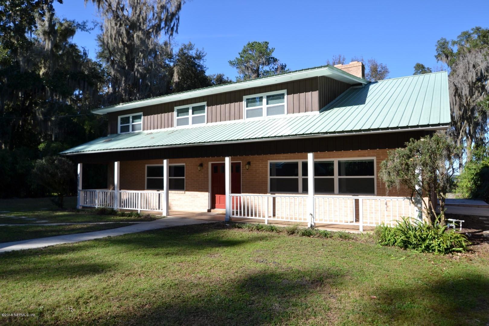 76 Harmony Hall Road Middleburg, FL 32068 - Photo 6 of 67 a front view of a house with a yard table and chairs