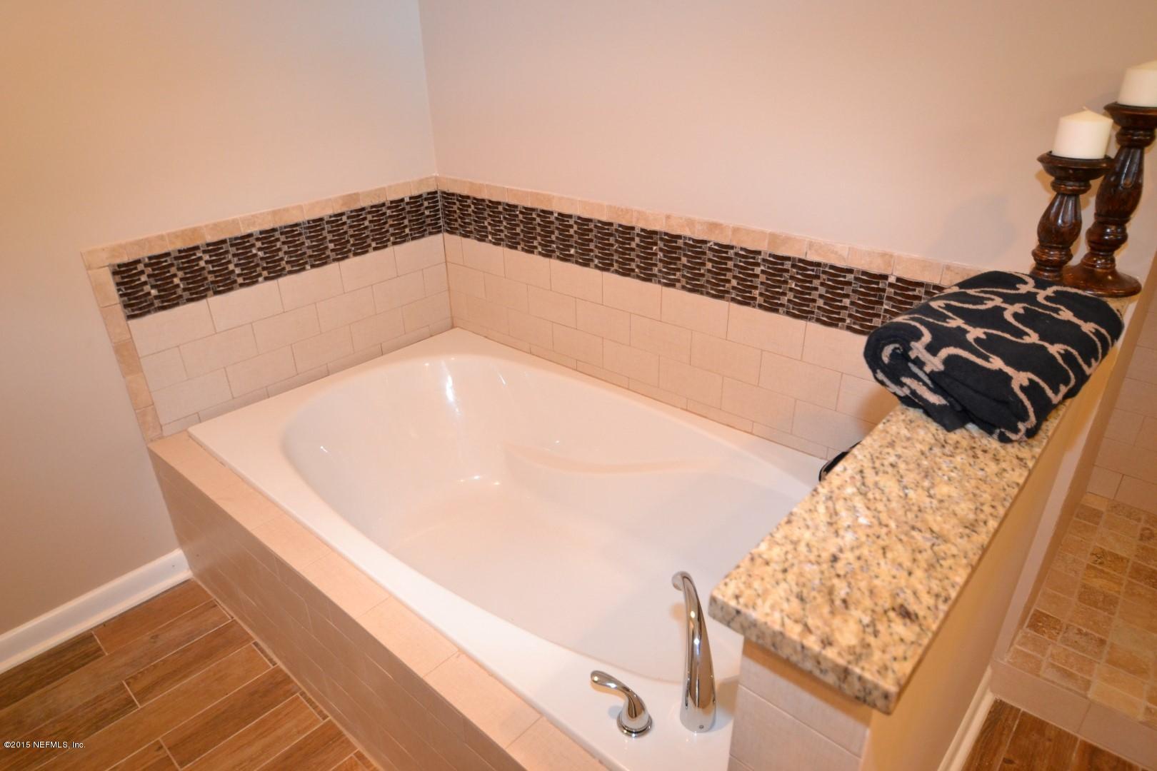 76 Harmony Hall Road Middleburg, FL 32068 - Photo 65 of 67 a bathroom with a bathtub