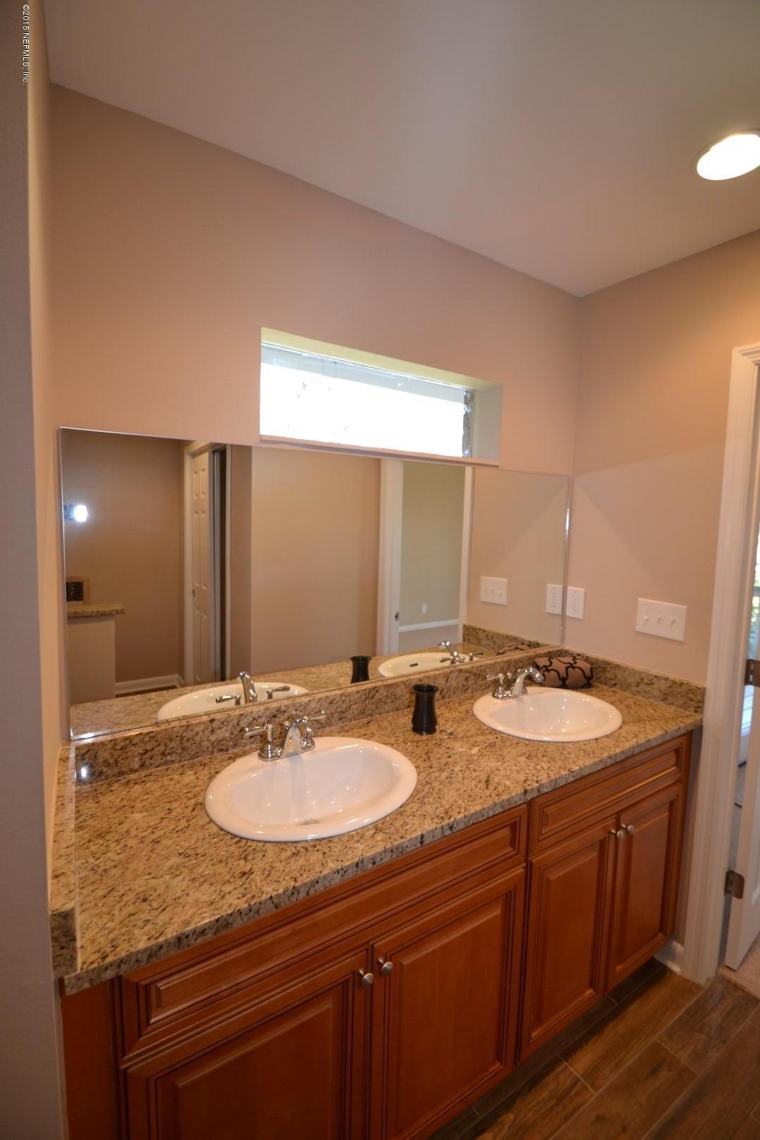 76 Harmony Hall Road Middleburg, FL 32068 - Photo 67 of 67 a bathroom with a granite countertop sink and a mirror