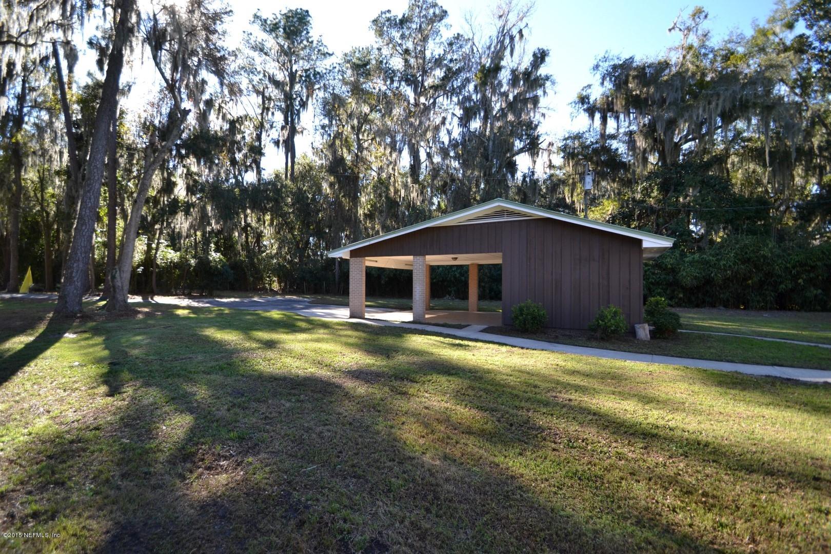 76 Harmony Hall Road Middleburg, FL 32068 - Photo 7 of 67 a view of a house with backyard and trees