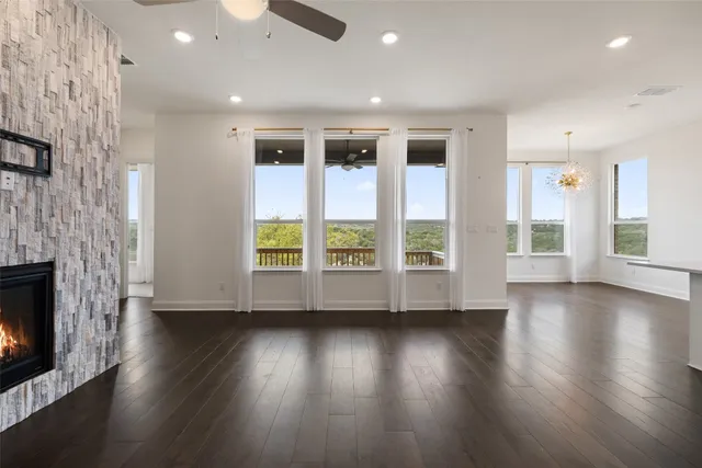 a view of a kitchen with wooden floor and a fireplace
