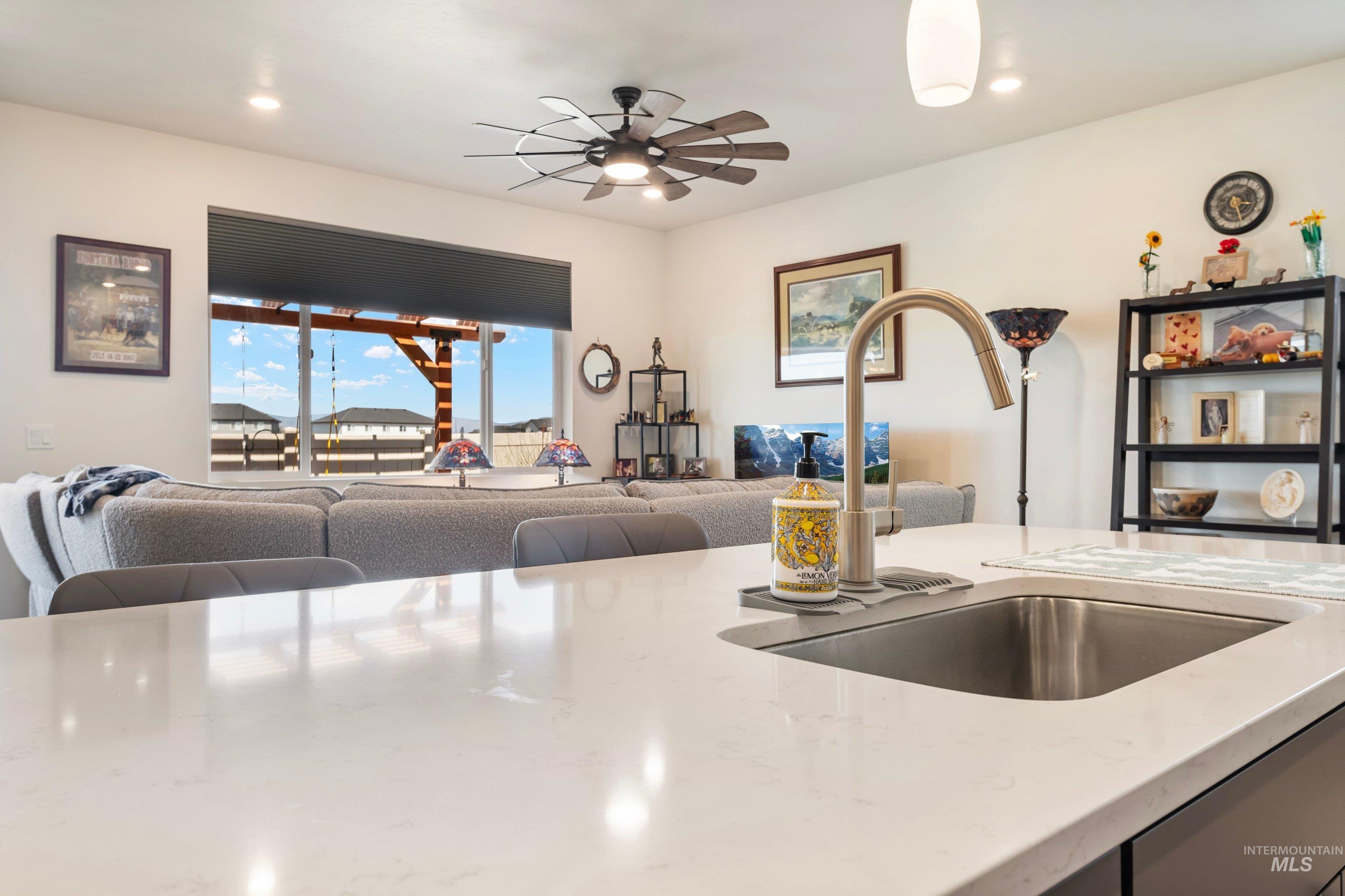 4232 South Graycliff Way Meridian, ID 83642 - Photo 15 of 34 Kitchen island with an undermount sink and a brushed nickel gooseneck faucet