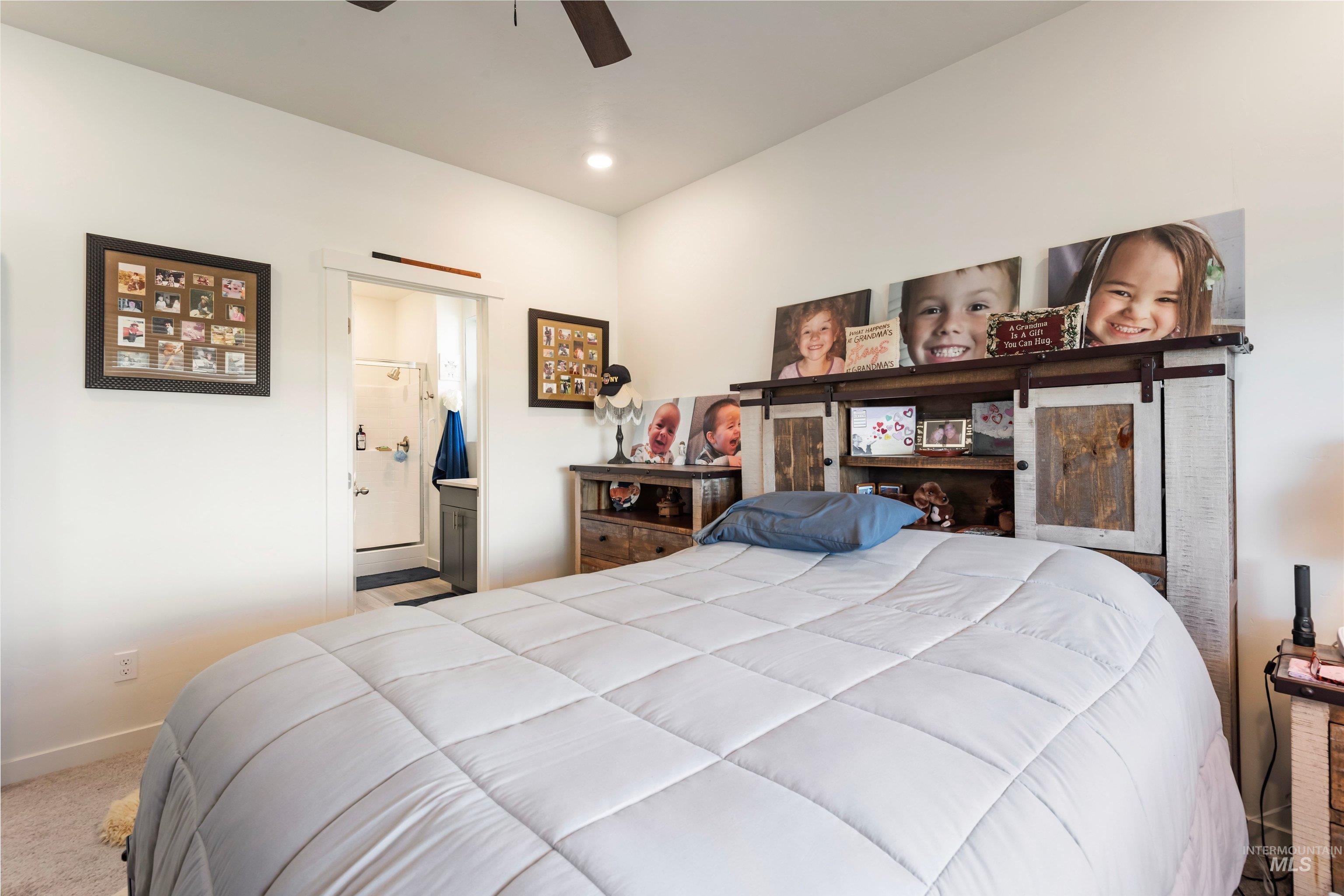 4232 South Graycliff Way Meridian, ID 83642 - Photo 17 of 34 Bedroom featuring a ceiling fan, recessed lighting, and a barn door entry to the en-suite bathroom