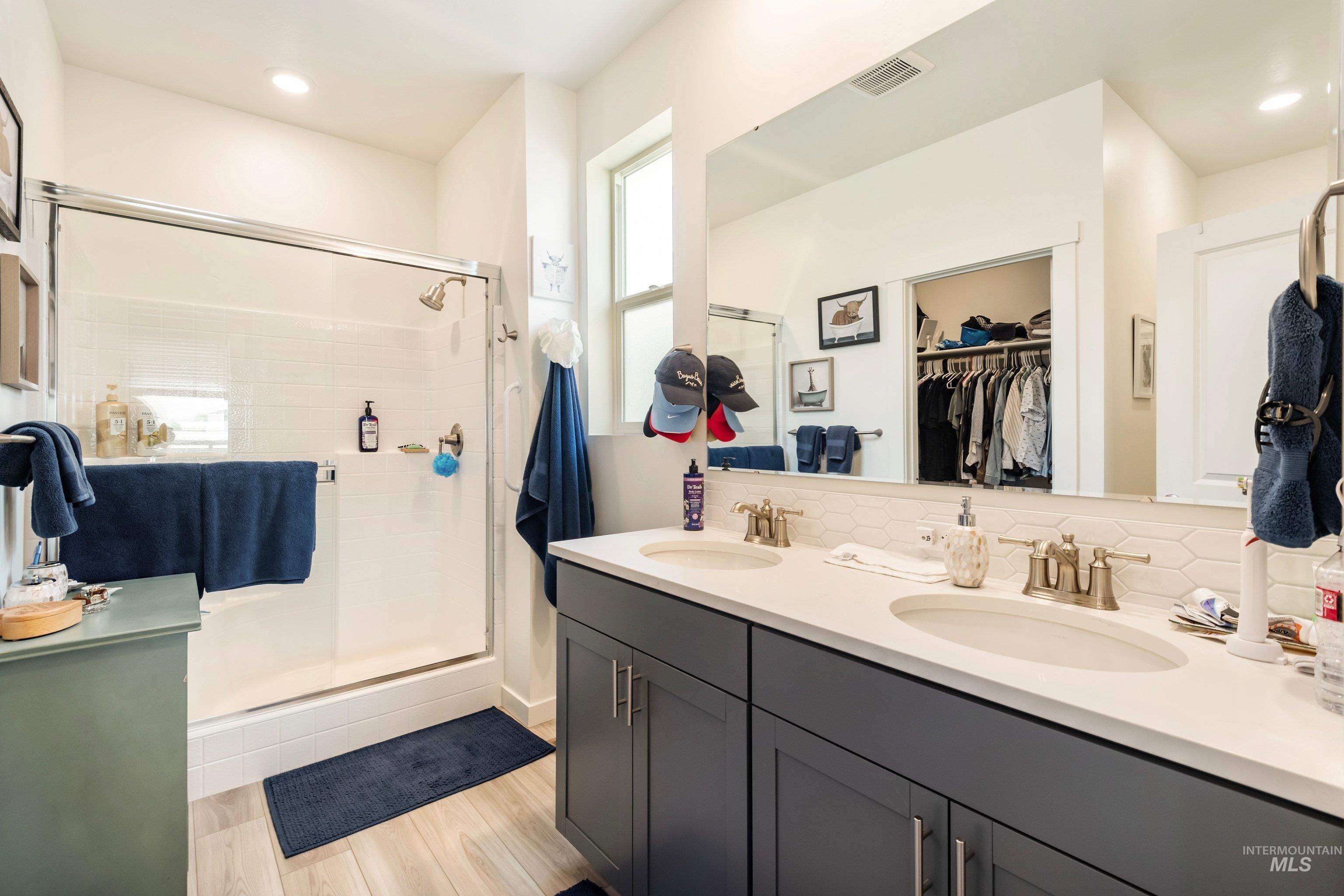 4232 South Graycliff Way Meridian, ID 83642 - Photo 18 of 34 Dual vanity with undermount sinks and dark cabinetry