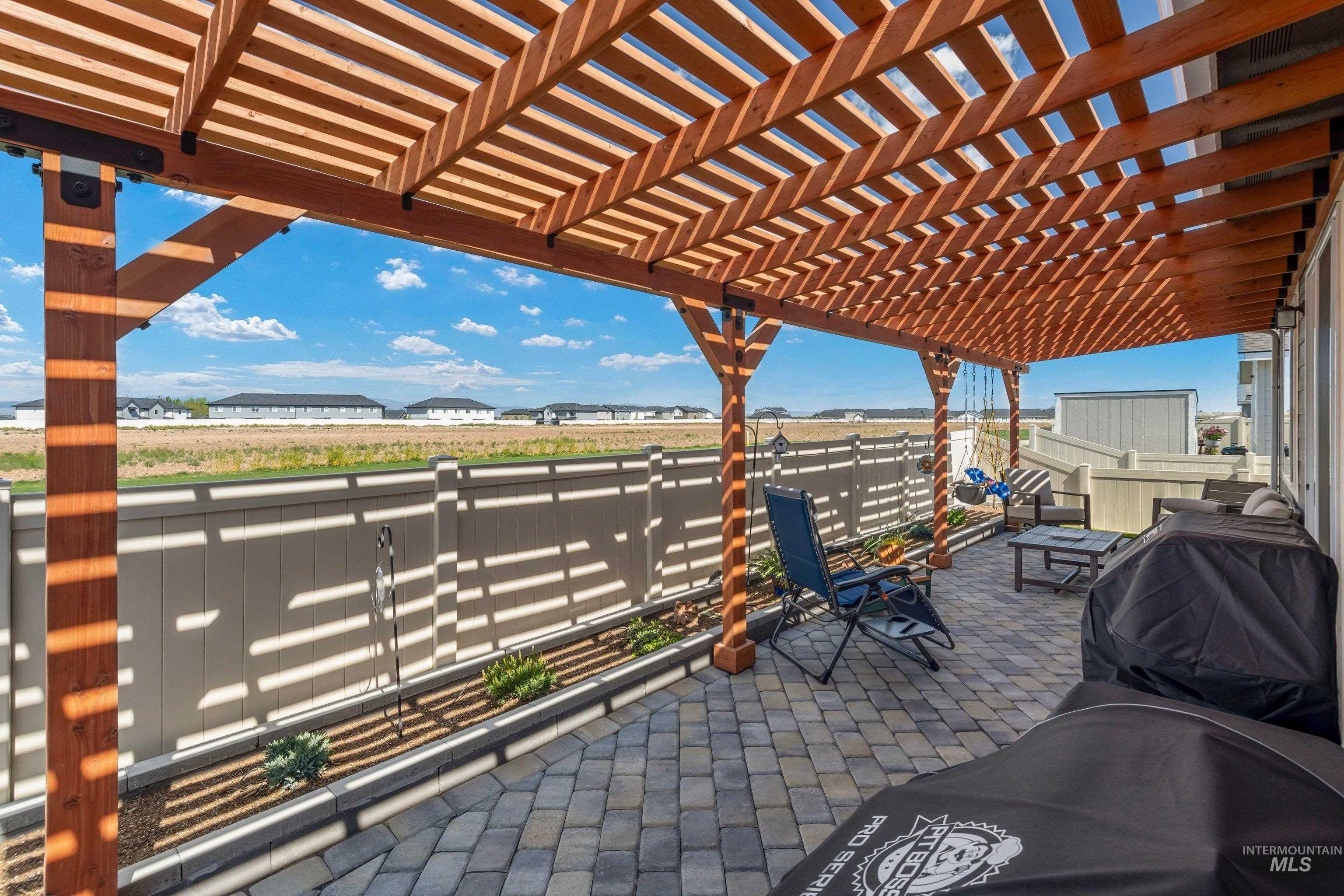 4232 South Graycliff Way Meridian, ID 83642 - Photo 24 of 34 Expansive patio featuring a wooden pergola and paver stone flooring