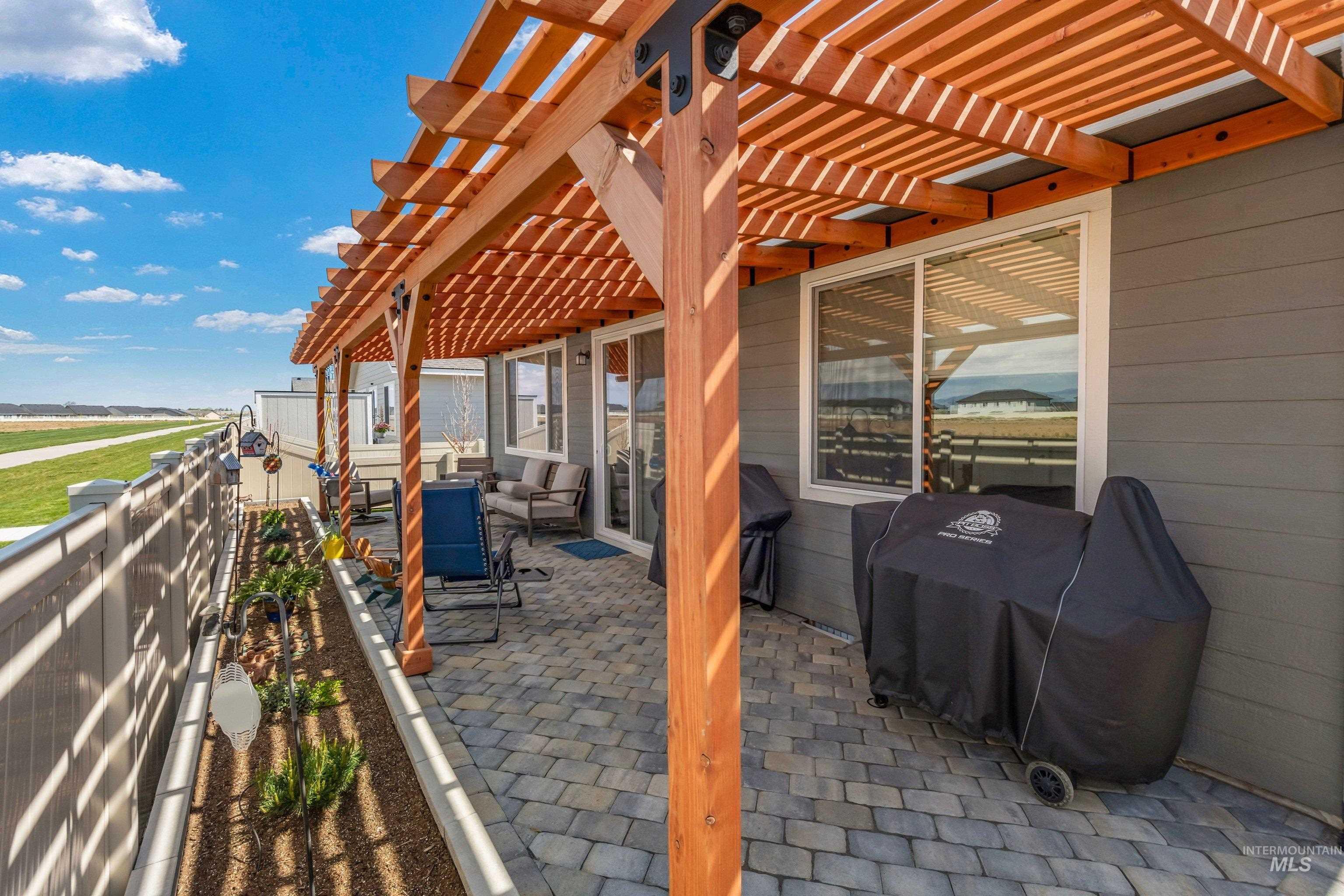 4232 South Graycliff Way Meridian, ID 83642 - Photo 25 of 34 Covered patio featuring a wooden pergola, paver flooring, and built-in planter