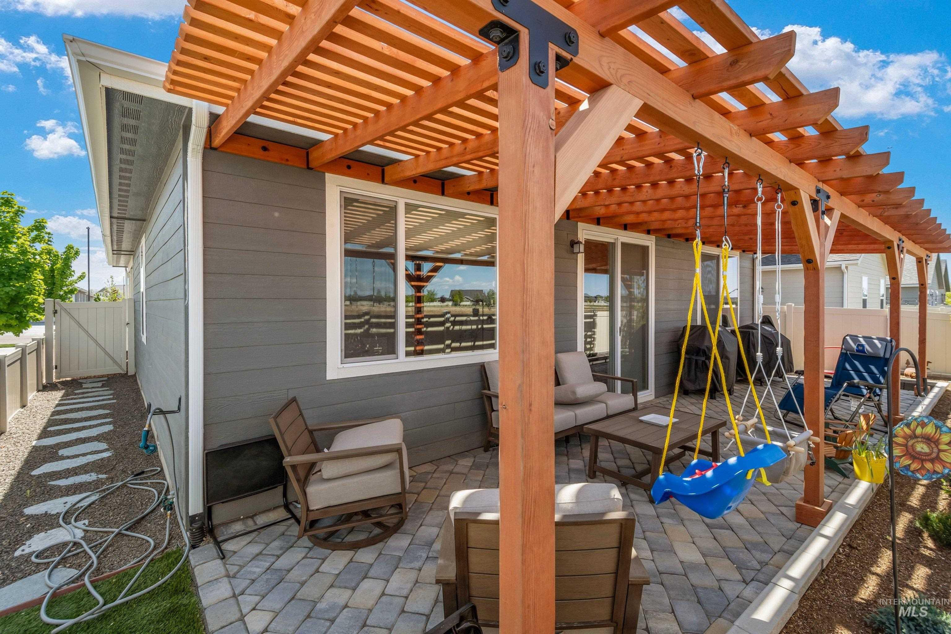 4232 South Graycliff Way Meridian, ID 83642 - Photo 26 of 34 Expansive paver patio featuring a wood pergola with black metal accents