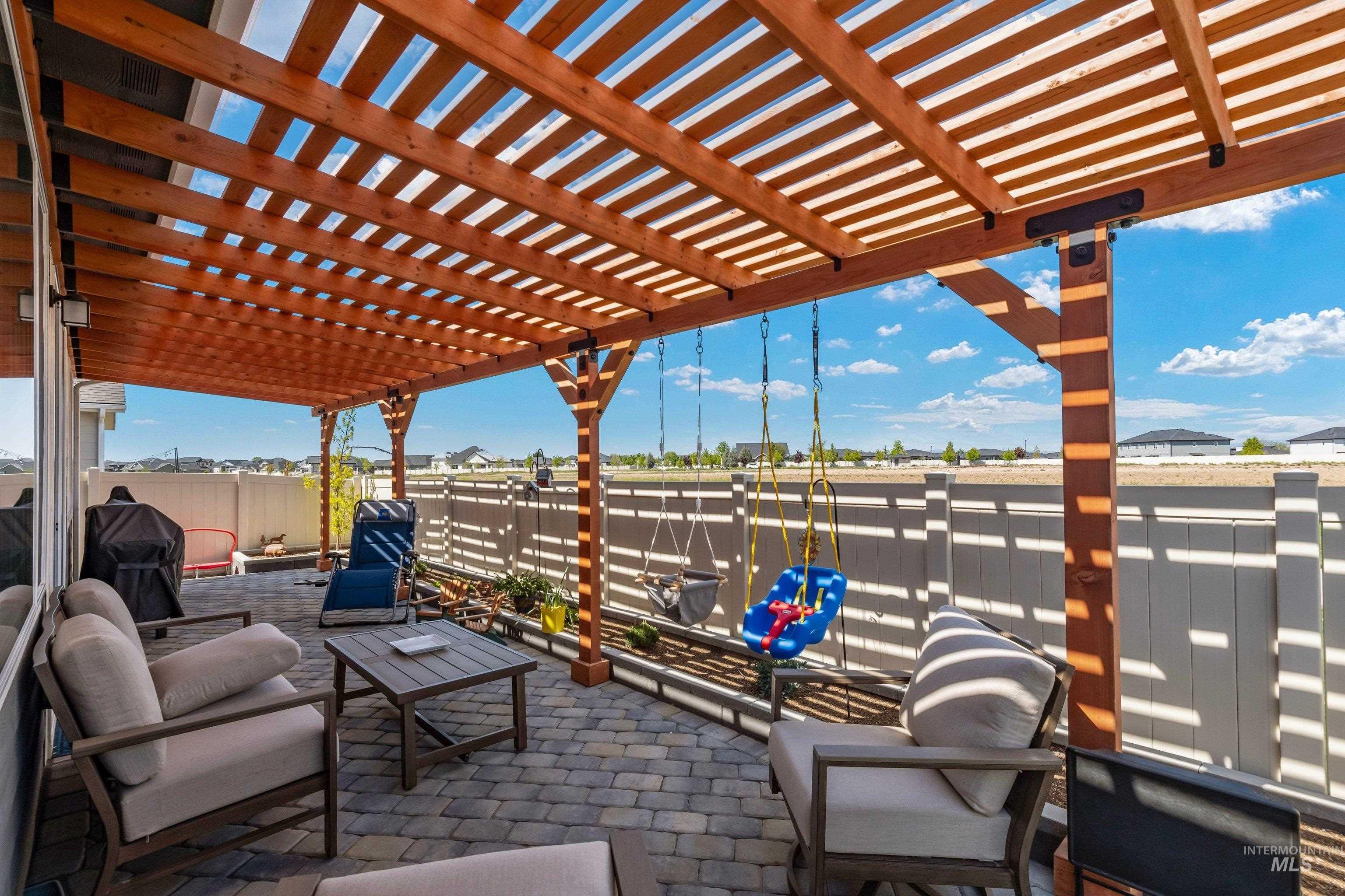 4232 South Graycliff Way Meridian, ID 83642 - Photo 27 of 34 Spacious patio featuring a wood pergola, paver flooring, and a privacy fence