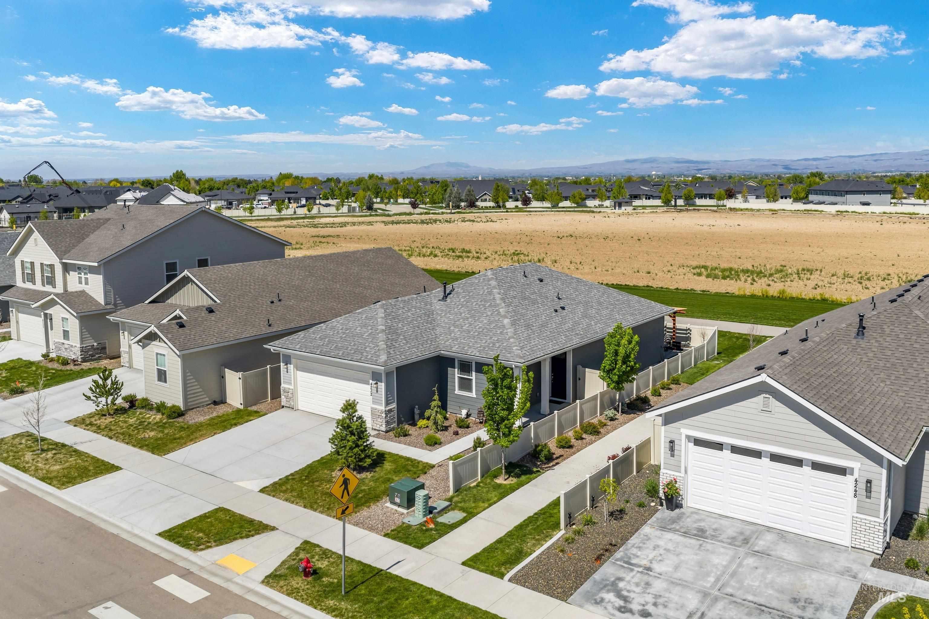 4232 South Graycliff Way Meridian, ID 83642 - Photo 28 of 34 Contemporary single-story residence featuring a gray exterior with stone accents and an attached two-car garage