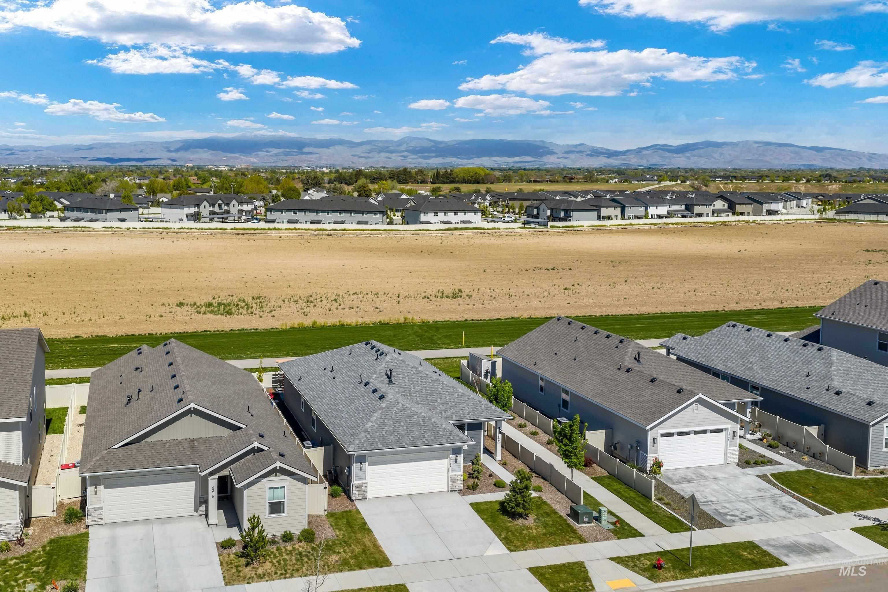 4232 South Graycliff Way Meridian, ID 83642 - Photo 29 of 34 Aerial perspective showcasing a residential area with detached single-story homes, individual driveways, and attached garages