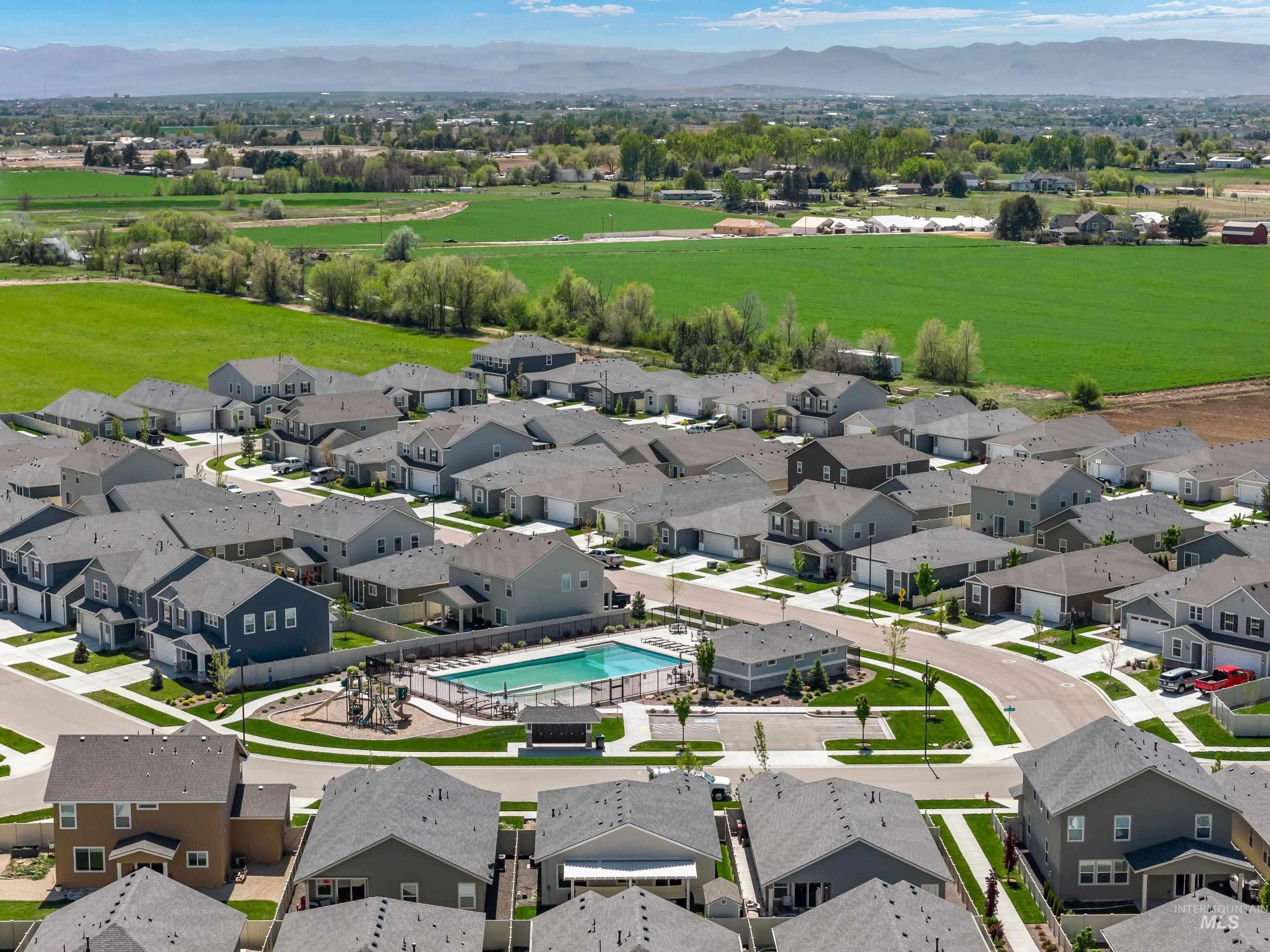 4232 South Graycliff Way Meridian, ID 83642 - Photo 33 of 34 Aerial overview of a residential community featuring varied single-family homes, an in-ground swimming pool, and a playground
