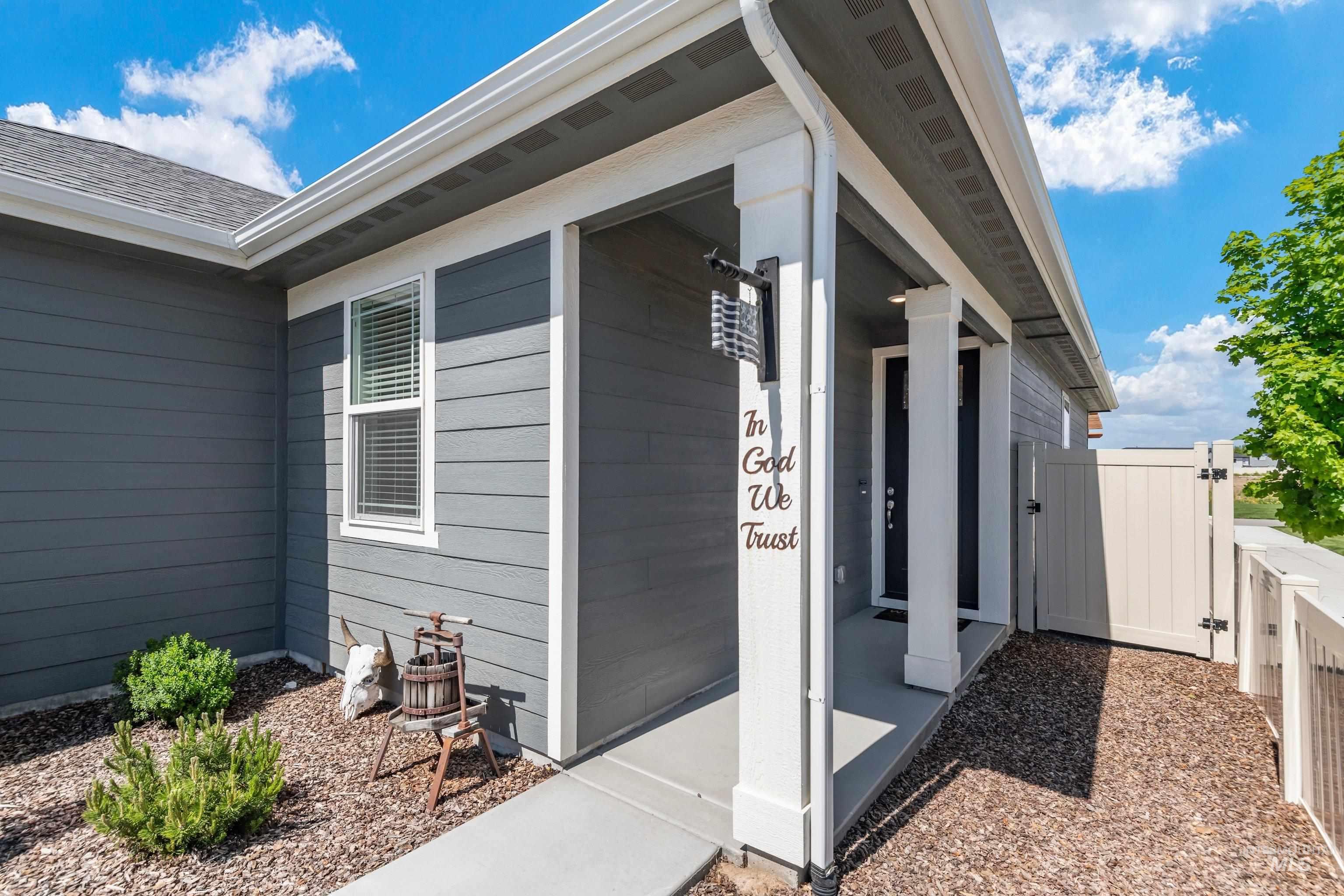 4232 South Graycliff Way Meridian, ID 83642 - Photo 7 of 34 Contemporary exterior featuring gray siding, white trim, and a covered entry