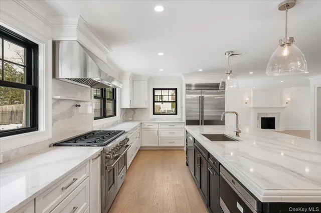 a kitchen with granite countertop a sink stove and cabinets
