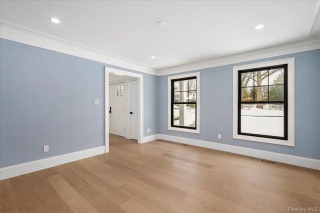 an empty room with windows and closet
