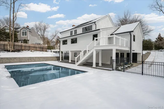 a view of a house with backyard porch and sitting area