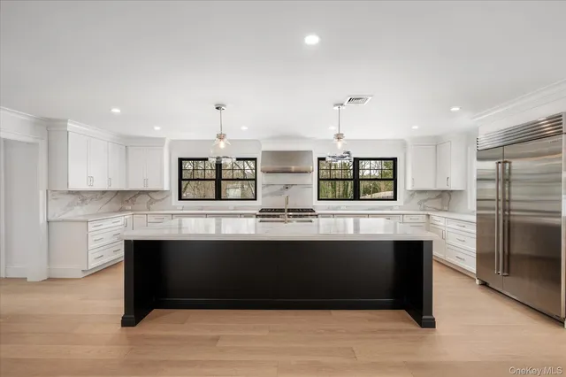 a kitchen with stainless steel appliances granite countertop a sink and stove top oven