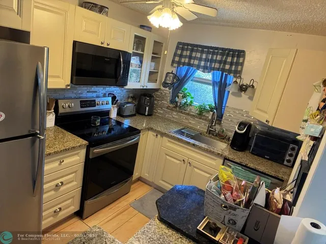 a kitchen with stainless steel appliances a stove a microwave and a refrigerator