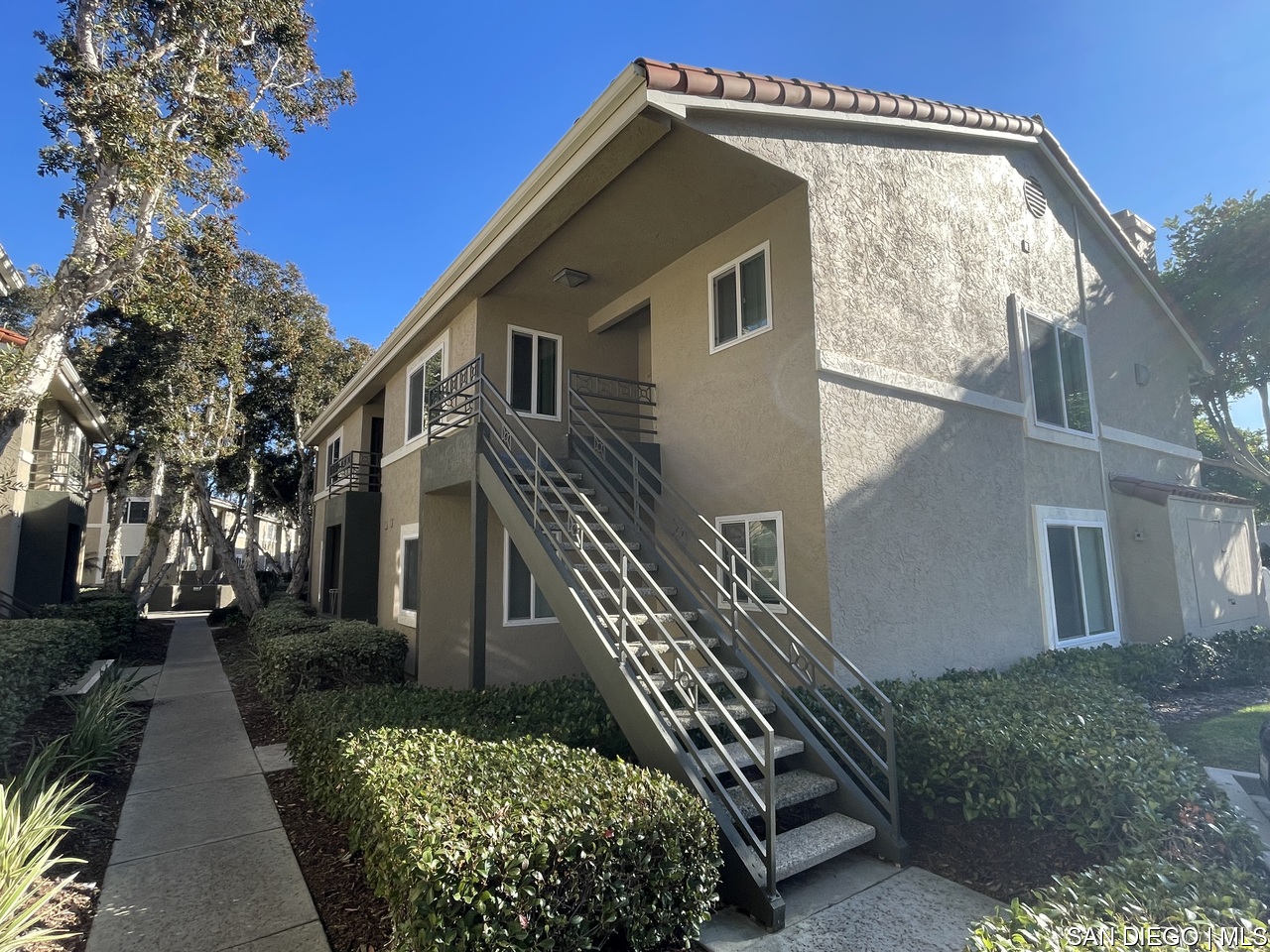 7535 Charmant Drive, Unit 201 San Diego, CA 92122 - Photo 1 of 22 a view of a house with a yard