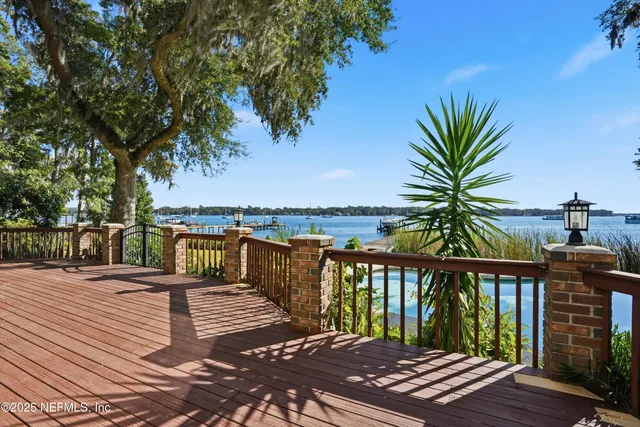 a balcony with wooden floor and city view